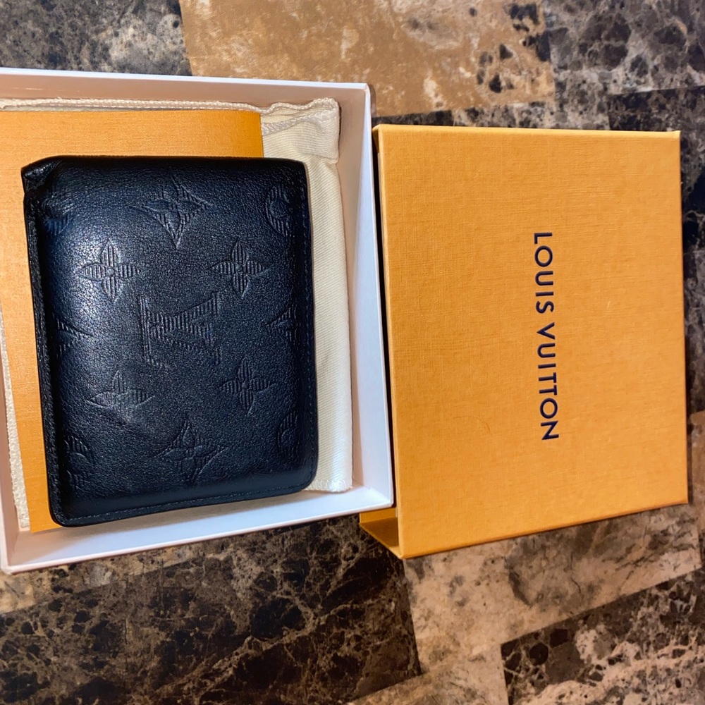 Black Louis Vuitton wallet. Covered in soft leather.